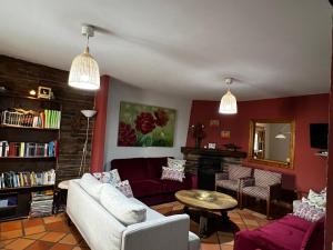 a living room with a couch and a table at Casa Rural Doña Catalina in Santa María la Real de Nieva