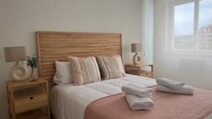a bedroom with a large bed with two pillows on it at Bellavetusta in Oviedo