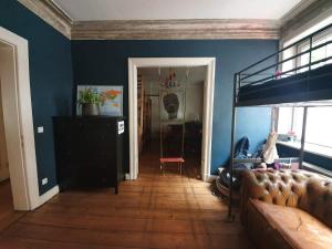 sala de estar con sofá y pared azul en Family Friendly Funhouse Centrally Located in Ottensen, en Hamburgo