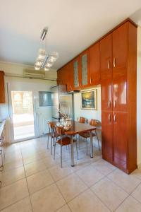 a kitchen with a table and chairs and a dining room at Mansion in Peraia by thesbnb in Perea