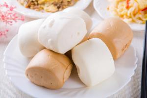 a plate of food with buns on a table at Yung An Business Hotel in Dounan