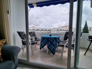 Zimmer mit einem Tisch und Stühlen auf einem Balkon in der Unterkunft Apartemento SOL in Alcossebre