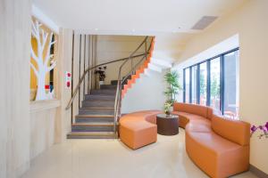 a living room with orange furniture and a staircase at Yung An Business Hotel in Dounan