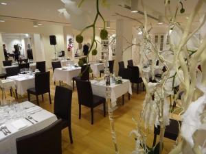 a dining room with white tables and black chairs at Terme Di Venturina - Toscana in Venturina Terme +85 photos
