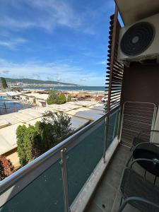 a balcony with chairs and a view of a city at Briz Beach apartments - section B in Sunny Beach