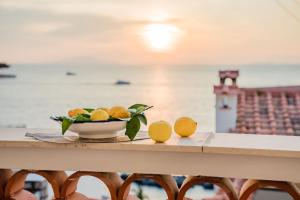 una ciotola di arance e una ciotola di limoni sul tavolo di La Maison De La Ville a Massa Lubrense
