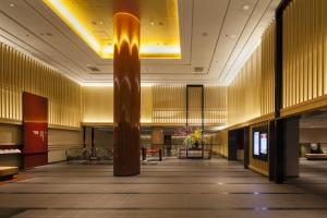 a lobby with a column in the middle of a building at Kyoto Tokyu Hotel in Kyoto