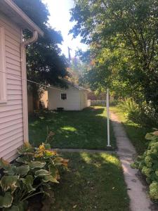 a yard with a house and a street at Spacious & Peaceful Home in the heart of Sheboygan in Sheboygan