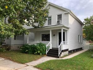 a white house with a white porch and a porch at Spacious & Peaceful Home in the heart of Sheboygan in Sheboygan