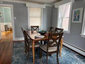 a dining room with a wooden table and chairs at Spacious & Peaceful Home in the heart of Sheboygan in Sheboygan