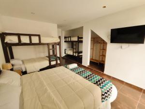 ルナウアナにあるJalara Lunahuaná Hotelのベッドルーム1室(二段ベッド2台、薄型テレビ付)が備わります。