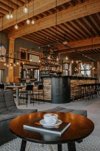 a room with a table and chairs and a bar at Villars Lodge in Villars-sur-Ollon +28 photos
