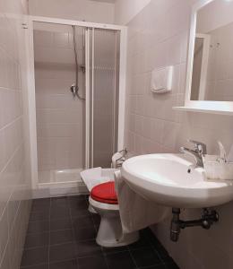 a bathroom with a toilet and a sink and a shower at Villa Al Piano in Lastra a Signa