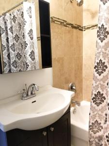 a bathroom with a sink and a shower at Spacious MBR Near Kennedy Subway & GO in Toronto