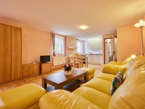 a living room with a yellow couch and a table at Studio U Šustrů by Interhome in Horní Maršov