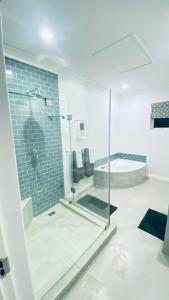 a bathroom with a shower with a glass door at Stylish Loft Style Apartment in Durban