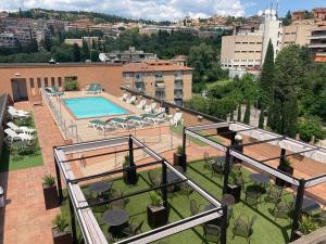 a balcony with a swimming pool on top of a building at Hotel Giò Wine e Jazz Area in Perugia