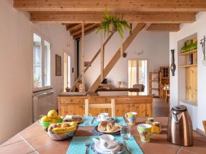 a kitchen with a table with a bowl of fruit on it at Holiday Home Alcunché by Interhome in Zafferana Etnea