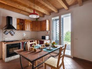 a kitchen with a table and a dining room at Holiday Home Alcunché by Interhome in Zafferana Etnea