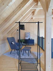 a living room with a chair and a table at Odenwald-Lodge mit Infrarotsauna und E-Ladestation im Naturpark Odenwald "Haus Himmelblau" in Reichelsheim