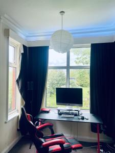 a computer sitting on a desk in front of a window at A wonderful room in Sale