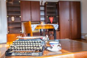 an old fashioned typewriter and a cup of coffee on a table at Socialist Experience in the City Center in Ljubljana