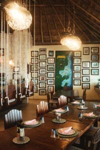 a dining room with a large wooden table and chairs at Grand Slam Fishing Lodge Tulum in Punta Allen