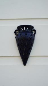 a black vase is hanging on a wall at riad casa bahia asilah in Asilah