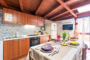 a kitchen with a table with dishes on it at Vista Sul Pan di Zucchero - Nebida - Holiday House in Nebida