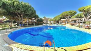 a swimming pool at a resort with dolphins in the water at #101 Kid Friendly with Pool, Private Park, 400 mts Beach in Albufeira