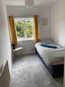 a small bedroom with a bed and a window at Charlie’s House Newmarket in Newmarket