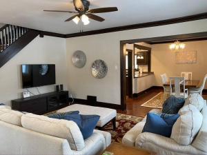 a living room with two couches and a ceiling fan at Serene Home One Block From Lake Michigan in Sheboygan