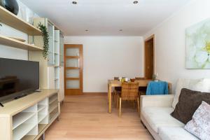 a living room with a couch and a table at AB San Mariano - Park Guell in Barcelona