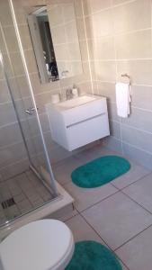 a bathroom with a toilet and a sink and a shower at Ballito Hills Lifestyle Estate Unit 423 in Ballito
