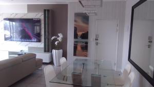 a living room with a glass table and a couch at Ballito Hills Lifestyle Estate Unit 423 in Ballito