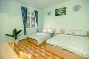 Ένα ή περισσότερα κρεβάτια σε δωμάτιο στο Coca homestay