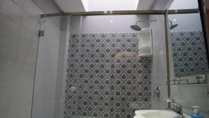 a bathroom with a shower and a sink at riad casa bahia asilah in Asilah