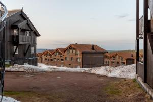 a parking lot in front of a group of buildings at Høyfjellsgrend 961, 29 B in Trysil