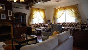 a living room with couches and a table and windows at casa bahia in Asilah