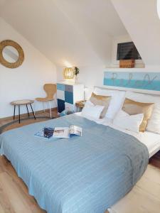 a bedroom with a large bed with a blue blanket at HangVilla Badacsony in Badacsonytomaj