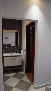 a bathroom with a sink and a mirror at riad casa bahia asilah in Asilah