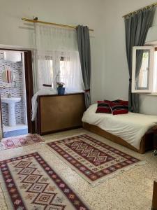 a bedroom with a bed and a window at Darna Hostel in Amman
