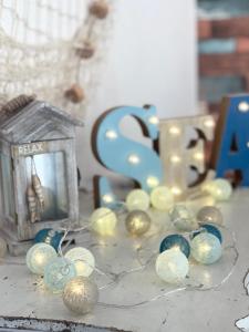 a table topped with christmas ornaments and a lantern at Home and Relax ROOMS in Furnari
