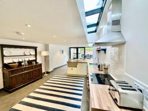 a kitchen with a sink and a stove at Laurel Cottage Sandsend in Sandsend