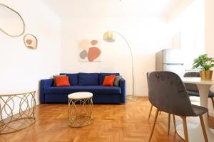 a living room with a blue couch and a table at Re di Roma - Charme Apartment in Rome