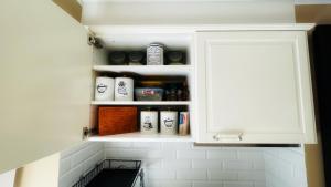 a cupboard with spices and other items on it at Pod Świerkami in Boszkowo
