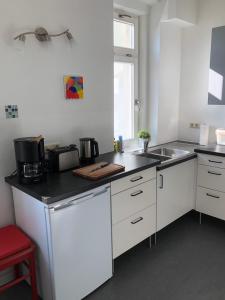 a kitchen with white cabinets and a sink at In der Mühlenstraße in Malchow