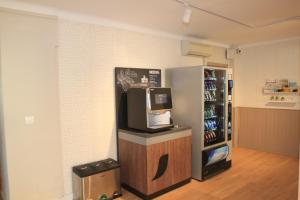 a room with a refrigerator and a counter with a television at Garau Petit Hotel in El Arenal