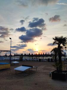 a group of ping pong tables on a beach at sunset at VILA IRINA in Mangalia
