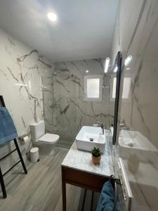 a bathroom with a sink and a toilet at Casa Marieta in Benissa